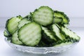 Slices of fresh green cucumber on a glass plate on a light background Royalty Free Stock Photo