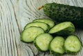 Slices of fresh green cucumber on a gray wooden background. Royalty Free Stock Photo