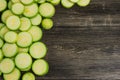 Slices of fresh green squash, zucchini, courgette  on wooden background Royalty Free Stock Photo