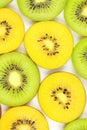 Slices of fresh green and yellow kiwi fruits food background texture Royalty Free Stock Photo