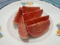 Slices of fresh guava fruit on white plate