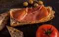 Slices of fresh homemade Alpine Baguette with jamon, olives and