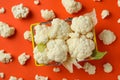 Slices of fresh juicy cauliflower in basket on orange background Royalty Free Stock Photo