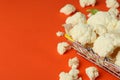 Slices of fresh juicy cauliflower in basket on orange background Royalty Free Stock Photo