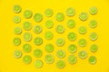 Slices of fresh juicy limes on yellow background Royalty Free Stock Photo