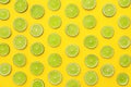 Slices of fresh juicy limes on yellow background Royalty Free Stock Photo