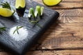 Slices of fresh lime, salt and rosemary on a wooden cutting Board Royalty Free Stock Photo