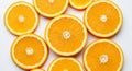 Slices of fresh oranges are arranged on a white background. The orange fruit sections display Royalty Free Stock Photo