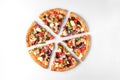 Slices of fresh round pizza with chicken meat, vegetables, mushrooms and cheese top view on a white and gray background Royalty Free Stock Photo