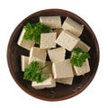 Slices of fresh tofu cheese in a clay bowl isolated on a white background. Soy cheese. Flat lay. Royalty Free Stock Photo