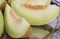 Slices of fresh yellow melon or cantaloupe on the old tray in Royalty Free Stock Photo