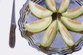 Slices of fresh yellow melon or cantaloupe on the old tray with Royalty Free Stock Photo