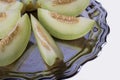 Slices of fresh yellow melon or cantaloupe on the old tray on Royalty Free Stock Photo