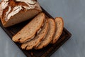 Slices freshly baked rye bread on brown cutting board, top view. Healthy yeast-free bread Royalty Free Stock Photo