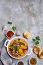 Slices of fried vegetables with sausages