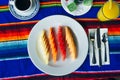 Slices of fruit beautifully sliced on a white plate in a restaurant. Mexican food