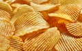 Slices Golden chips with stripes lying slides background texture. Side view
