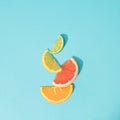 Slices of grapefruit, orange, lemon and lime standing on top of each other. Blue background Royalty Free Stock Photo