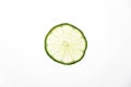 Slices of green fresh lime on a white background on the lumen. Royalty Free Stock Photo