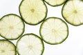 Slices of green fresh lime on a white background on the lumen. Royalty Free Stock Photo