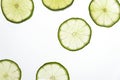 Slices of green fresh lime on a white background on the lumen. Royalty Free Stock Photo