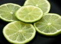 SLICES OF GREEN LEMON citrus aurantifolia Royalty Free Stock Photo