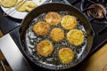 Slices of green tomato being fried Royalty Free Stock Photo