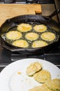 Slices of green tomato being fried Royalty Free Stock Photo