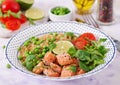 Slices of grilled salmon, quinoa, green peas, tomato, lime and lettuce leaves Royalty Free Stock Photo