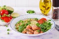 Slices of grilled salmon, quinoa, green peas, tomato, lime and lettuce leaves Royalty Free Stock Photo