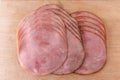 Slices of ham on a wooden chopping board Royalty Free Stock Photo