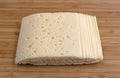 Slices of Havarti cheese on a cutting board Royalty Free Stock Photo