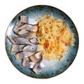 Slices herring fish with pickled cabbage, served on plate Royalty Free Stock Photo