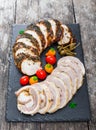 Slices of Homemade meatloaf, veal and pork tenderloin stuffed with vegetables on black slate stone chalkboard Royalty Free Stock Photo