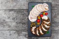 Slices of Homemade meatloaf, veal and pork tenderloin stuffed with vegetables on black slate stone chalkboard on wooden background Royalty Free Stock Photo