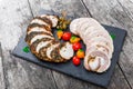 Slices of Homemade meatloaf, veal and pork tenderloin stuffed with vegetables on black slate stone chalkboard Royalty Free Stock Photo