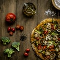 Slices of homemade pizza with vegetables tomatoes, mushrooms, cauliflower and an oilcan on a natural wooden table Royalty Free Stock Photo