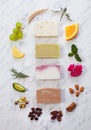 Slices of homemade soap in circle of natural ingredients