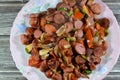 Slices hot dog grilled beef sausage called wiener (Vienna sausage) and frankfurter frank, with slices of tomato Royalty Free Stock Photo