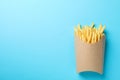 Slices of hot french fries in box on background, space for text. Top view Royalty Free Stock Photo