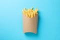 Slices of hot french fries in box on background, space for text. Top view Royalty Free Stock Photo