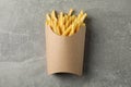 Slices of hot french fries in box on background, space for text. Top view Royalty Free Stock Photo