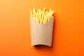 Slices of hot french fries in box on background, space for text. Top view Royalty Free Stock Photo