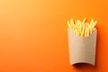 Slices of hot french fries in box on background, space for text. Top view Royalty Free Stock Photo