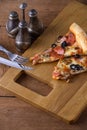 Slices italian pizza on wooden board