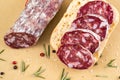 Slices of italian salami on bread and some spices Royalty Free Stock Photo