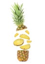 Slices of juicy pineapple flying between its top and bottom on white background Royalty Free Stock Photo