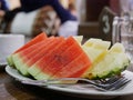 Slices of juicy and tasty watermelon and pineapple served on a table during a Khantok dinner