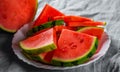 Slices of juicy watermelon on white plate on wooden table Royalty Free Stock Photo