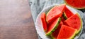 Slices of juicy watermelon on white plate on wooden table Royalty Free Stock Photo